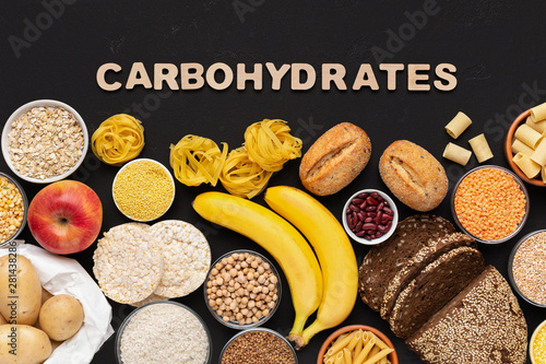 Fotografie Healthy food with carbohydrates on black background