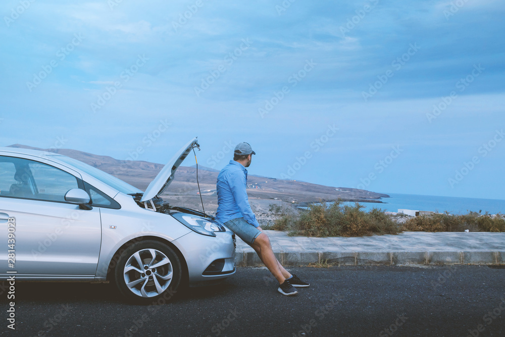 Angry man sitting on a broken car Angry man sitting on a broken car
