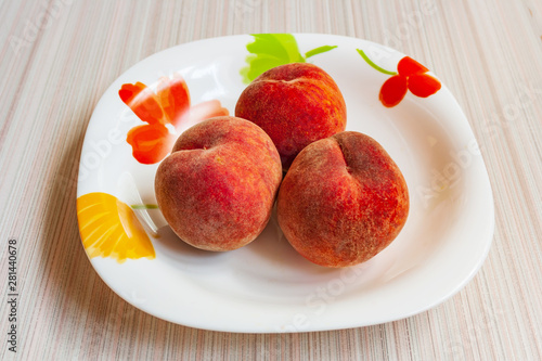ripe fruit peaches three pieces on a plate, in a Cup, in a bowl