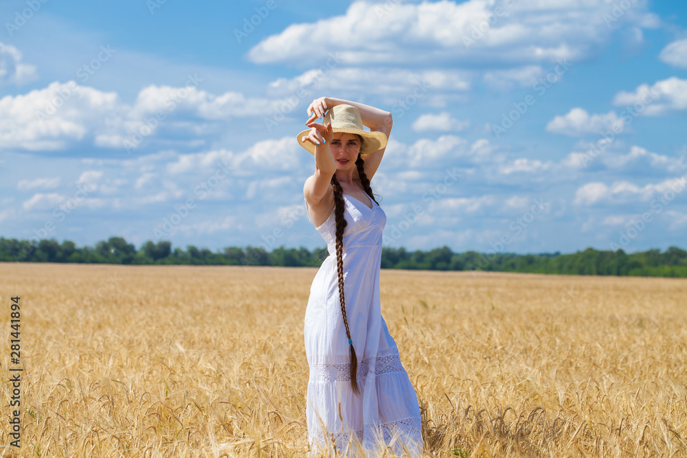Young brunette woman in white dress walking in a wheat field Young brunette woman in white dress walking in a wheat field