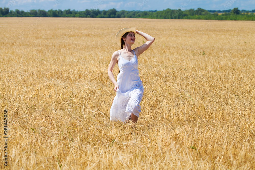 Young brunette woman in white dress walking in a wheat field Young brunette woman in white dress walking in a wheat field