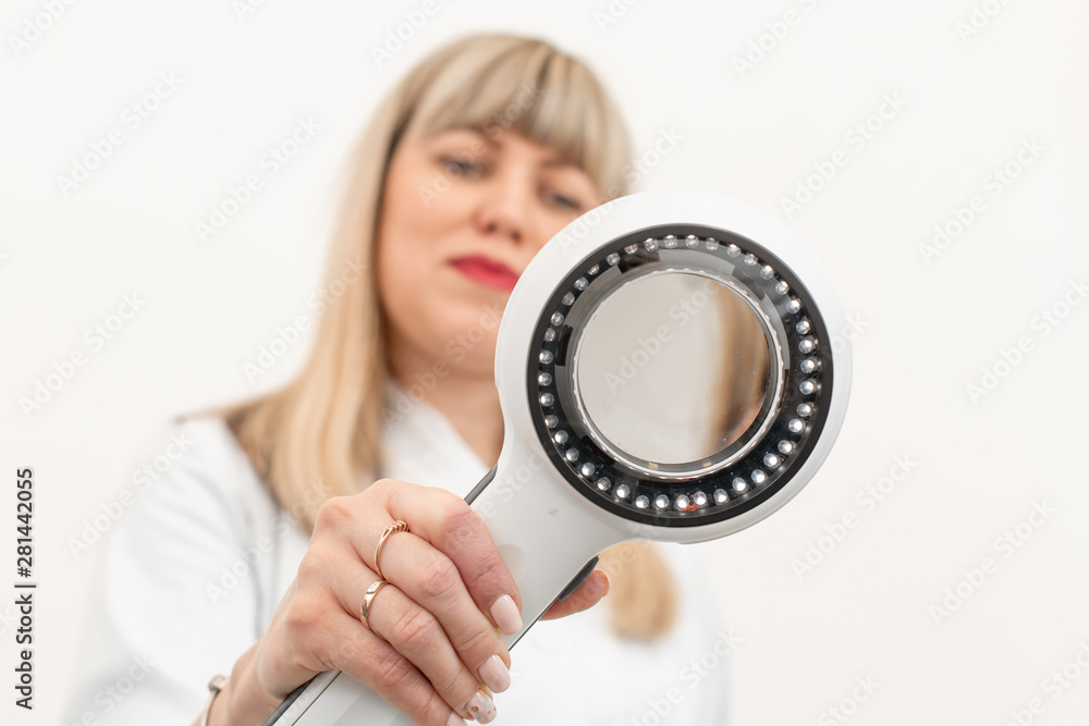 The doctor trichologist dermatologist examines the camera through the dermatoscope The doctor trichologist dermatologist examines the camera through the dermatoscope