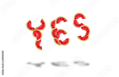 word yes laid out from pieces of ripe red watermelon with seeds isolated on white background