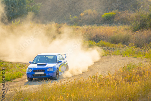 Blue Rally Car Passes Turn of the Road © goodman_ekim