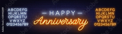 Happy anniversary neon sign. Greeting card on dark background.