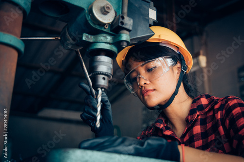 Asian beuatiful woman working with machine in the factory engineer and working woman concept or woman day