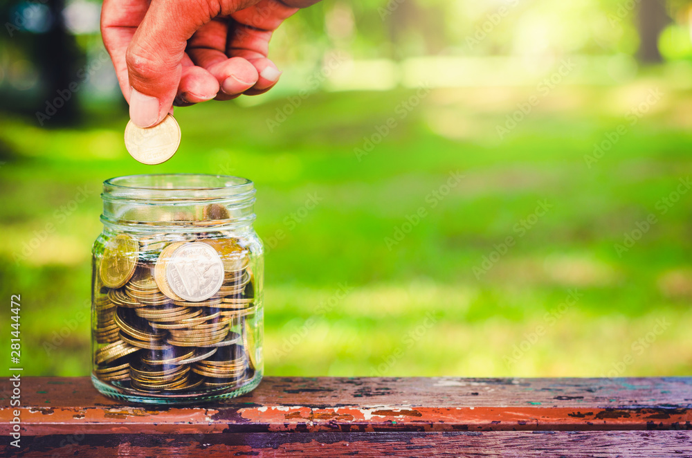 businessman putting coin in to glass jar count the money for saving concept. budgeting for investment startup business. businessman putting coin in to glass jar count the money for saving concept. budgeting for investment startup business.