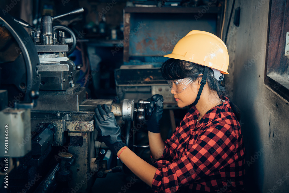 Asian beuatiful woman working with machine in the factory engineer and working woman concept or woman day Asian beuatiful woman working with machine in the factory engineer and working woman concept or woman day