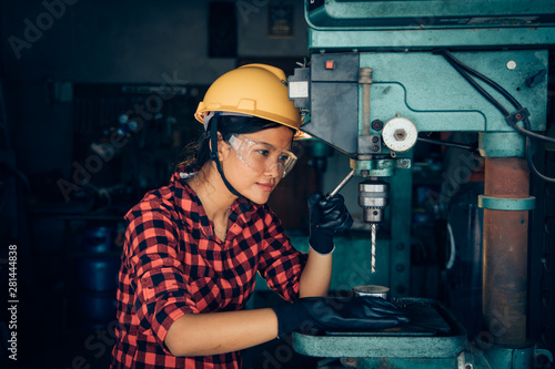 Asian beuatiful woman working with machine in the factory engineer and working woman concept or woman day