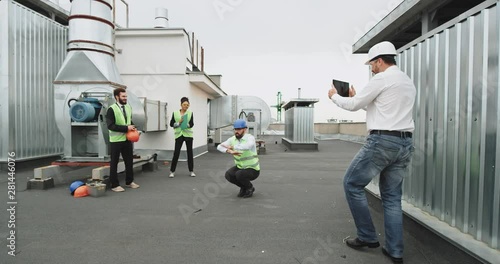 The bearded man dances passionately and shows off his best moves , the construction lady dances with him to the beat photo