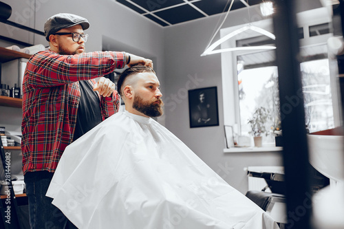 Man with a beard. Hairdresser with a client. Man in a red shirt
