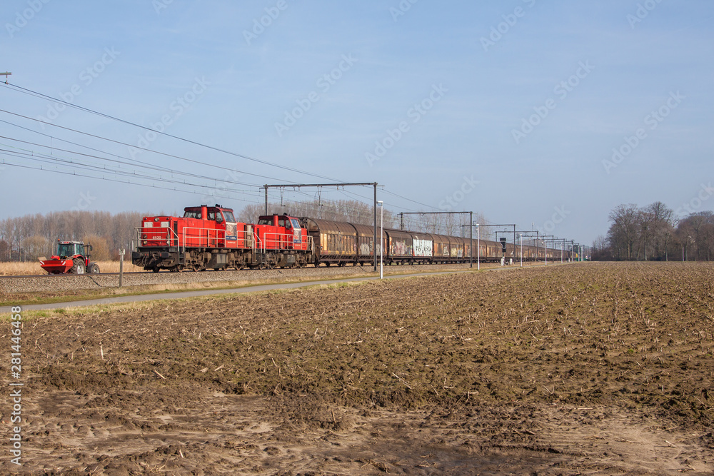 2 red locomotives and a red tractor