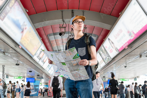 Wallpaper Mural Asian man traveller with map in the skytrain station. Torontodigital.ca