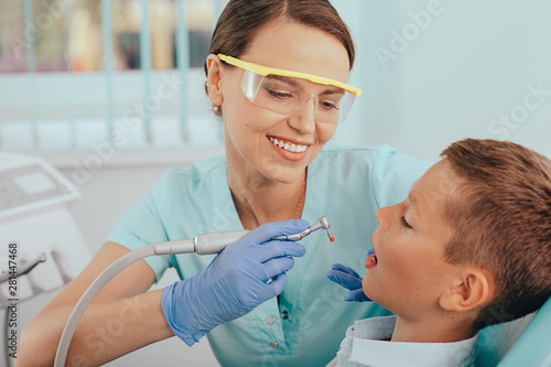 Dentist working on little patient's teeth in medical clinic