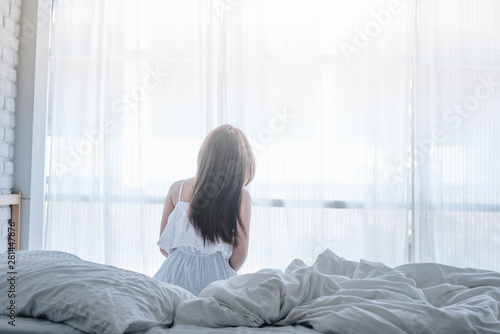 Woman wake up on her bed in the morning.