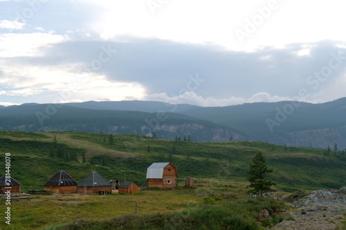 Nearby are small wooden houses with iron roofs. Nature of Altai.