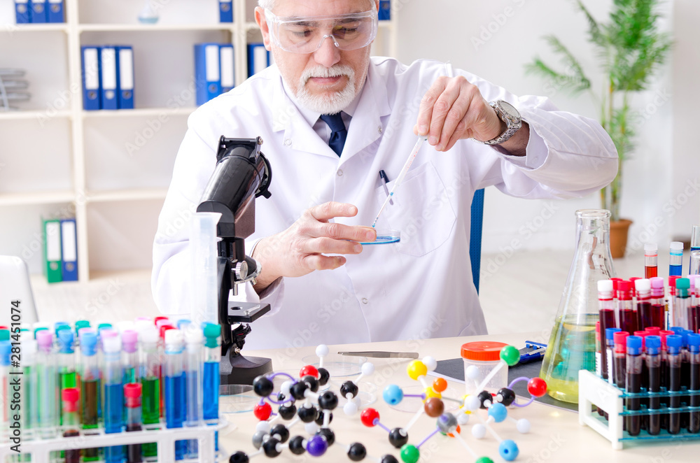 Old male chemist working in the lab Old male chemist working in the lab