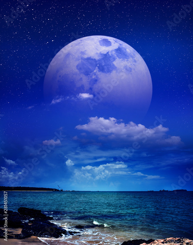 Beautiful sky with super moon behind partial cloudy over seascape. Serenity nature background.