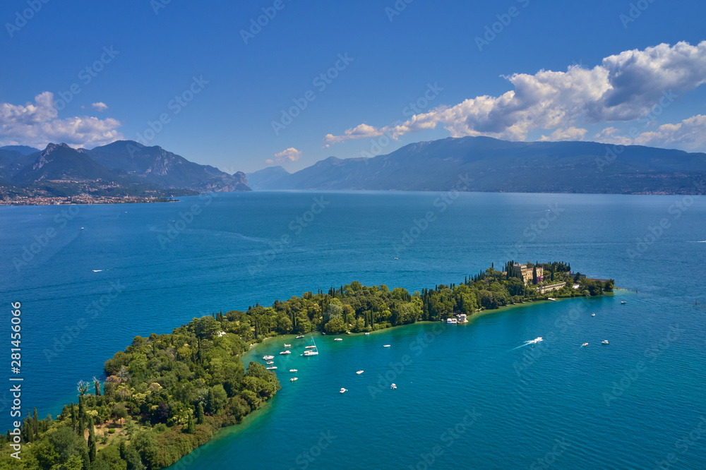 Unique view of the island of Garda. In the background is the Alps. Resort place on Lake Garda north of Italy. Aerial photography.