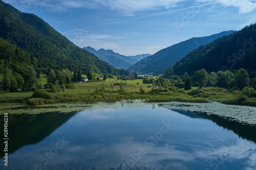 Fototapeta Naklejka Na Ścianę i Meble -  Aerial photography. Panoramic view of a small lake north of Italy. Trento region. Great trip to the lake in the Alps.