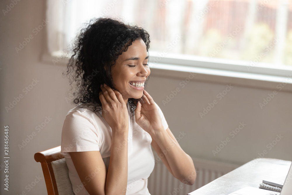 Cheerful african woman feels happy received great news on computer Cheerful african woman feels happy received great news on computer