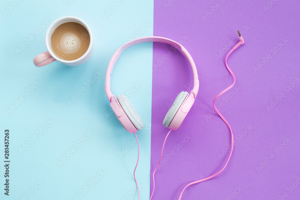 Pink headphones and coffee cup on color background. Music concept Pink headphones and coffee cup on color background. Music concept