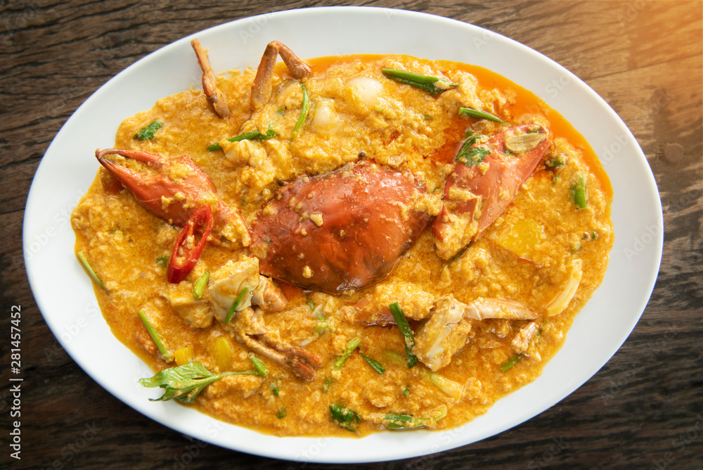 Fried crab with curry powder,one of the popular food in Thailand with a wood table background Fried crab with curry powder,one of the popular food in Thailand with a wood table background