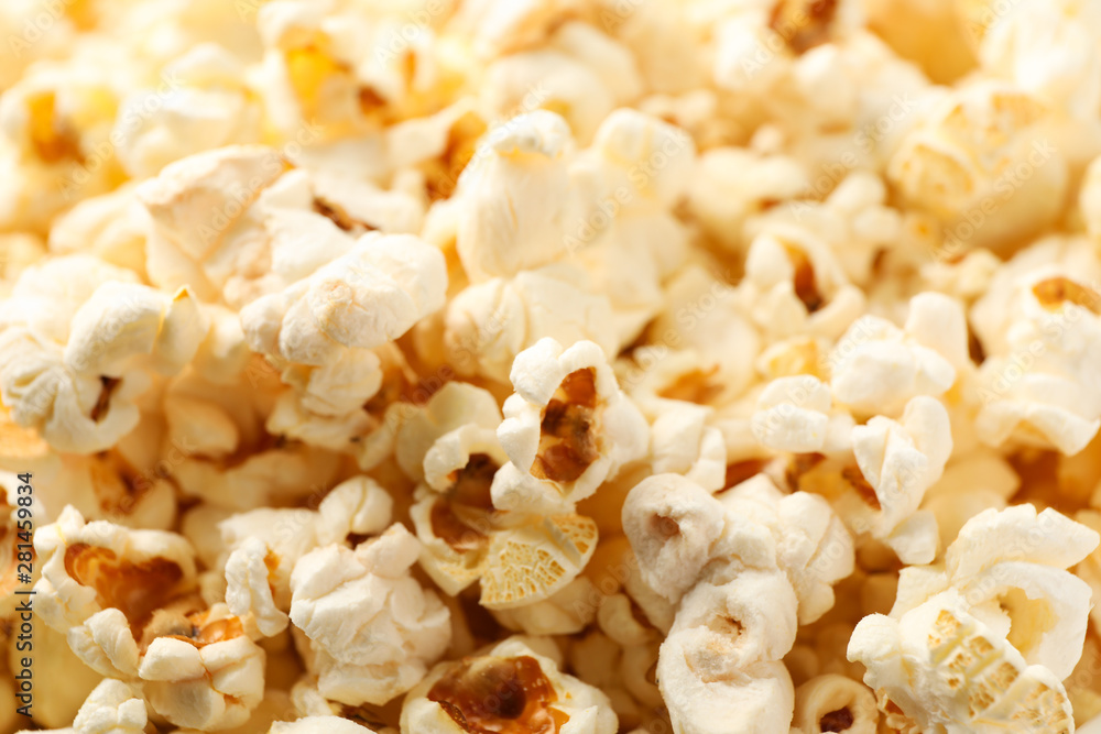 Delicious popcorn on whole background, close up Delicious popcorn on whole background, close up