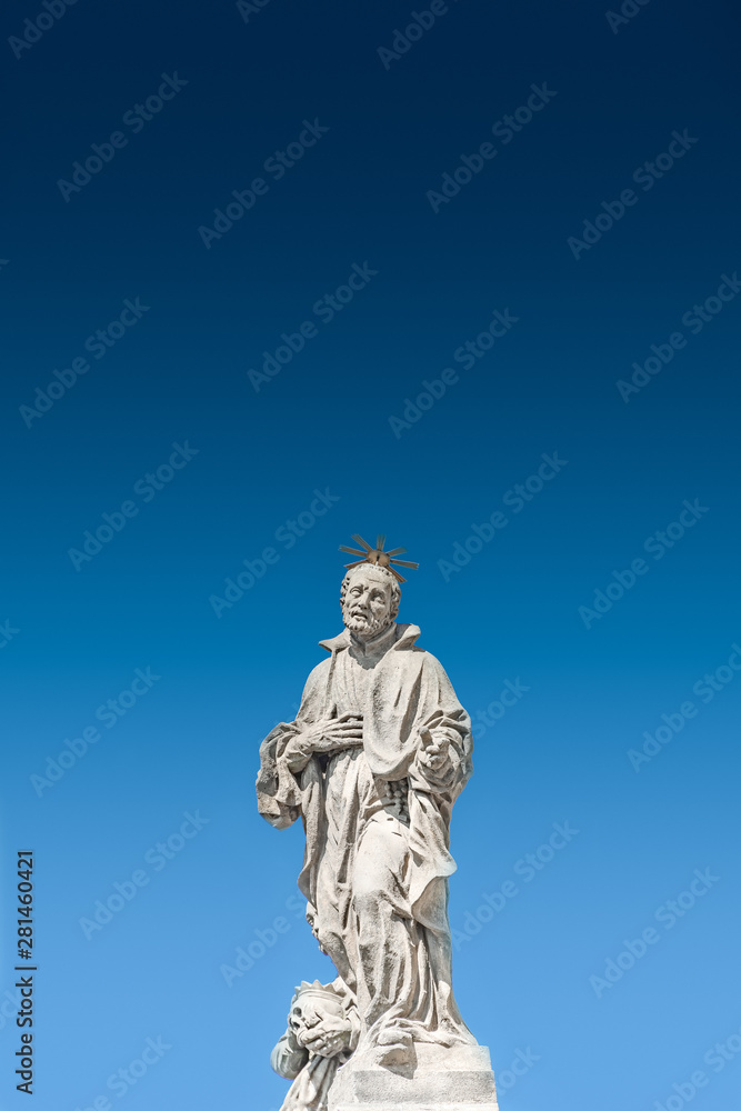 Sculptures at Jesuit church of St. Ignatius of Loyola at Charles Square in Prague at smooth gradient background, Czech Republic, summer time, details