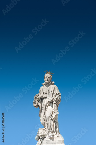 Sculptures at Jesuit church of St. Ignatius of Loyola at Charles Square in Prague at smooth gradient background  Czech Republic  summer time  details
