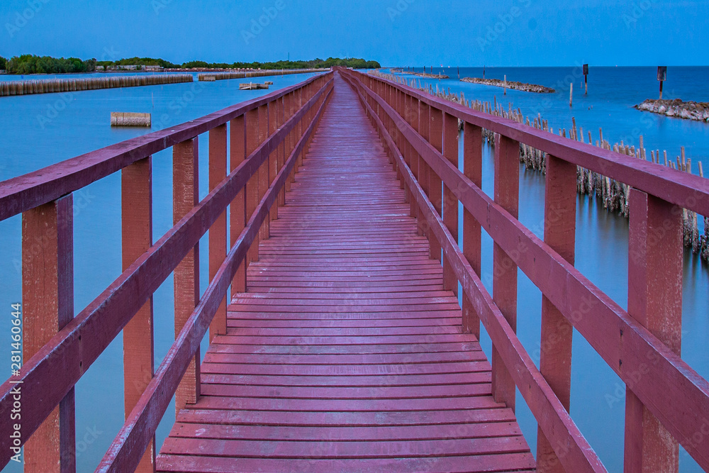 Beautiful of The walkway red wooden bridge in evening at Bang Khun Thian sea view, Bang Khun Thian, Bangkok.