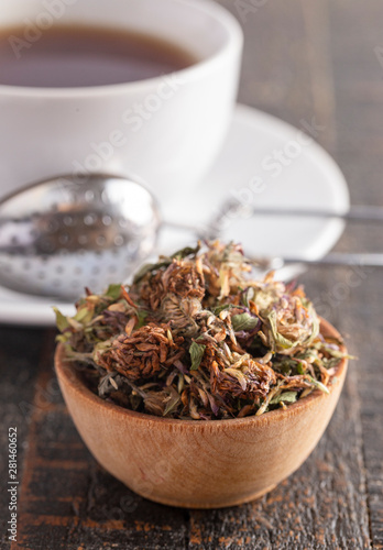Dried Red Clover Flowers and Leaves on a Wooden Table