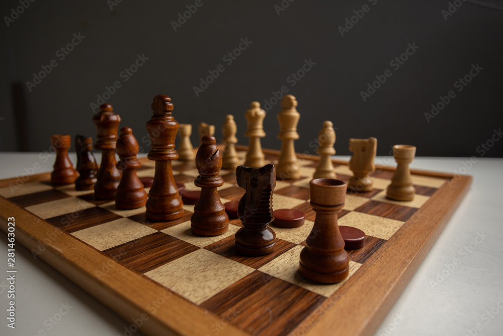 Chess placed on a wooden table,concept : of business strategy and tactic battle,symbol competition game success play victory war Chess placed on a wooden table,concept : of business strategy and tactic battle,symbol competition game success play victory war