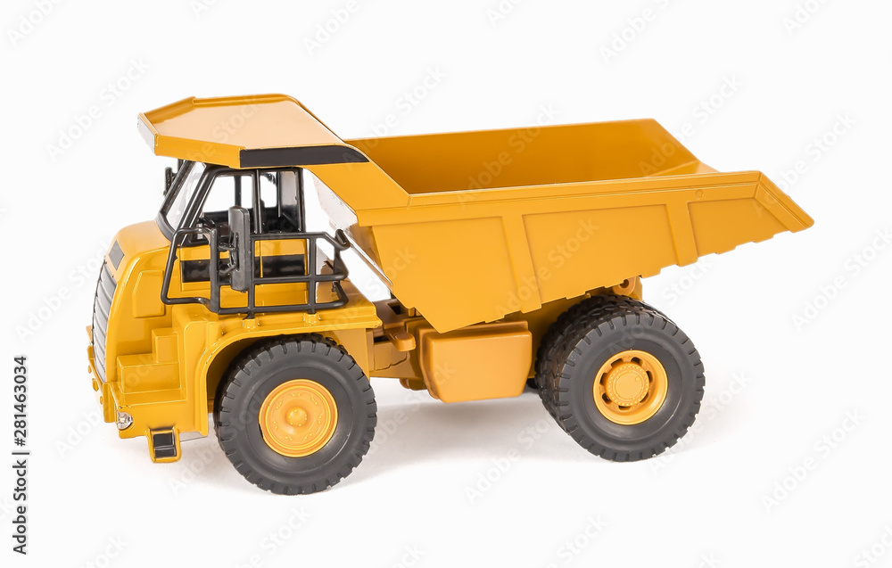 Toy dump truck with open-box bed. Children's toy plastic haul truck car with isolated on white background