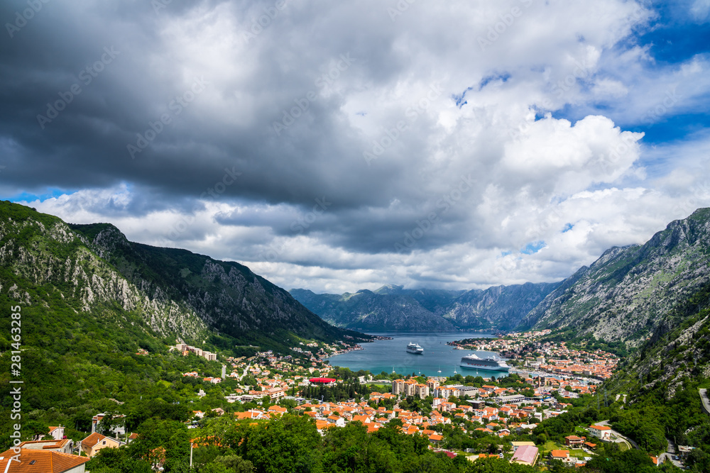 Montenegro, Beautiful bay of kotor city houses and harbor with two cruise ships surrounded by majestic mountains nature landscape