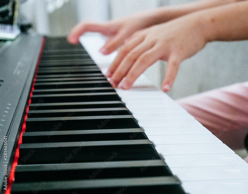 Close-up Finger playing piano keyboard.
