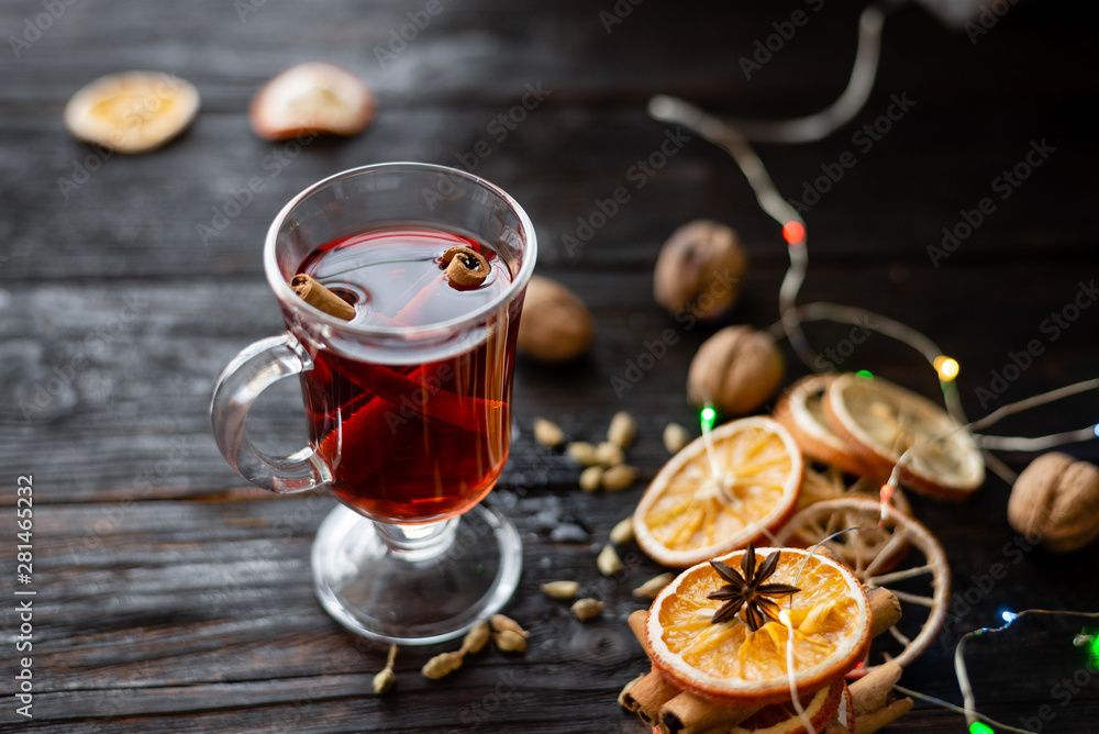 a glass of aromatic mulled wine on the table, a delicious wine with spices a glass of aromatic mulled wine on the table, a delicious wine with spices