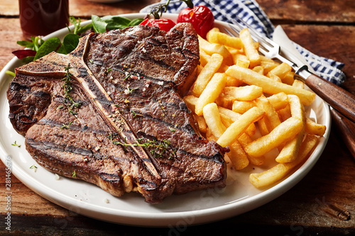 Obraz na płótnie Tasty grilled T-bone steak seasoned with herbs