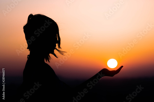Woman holding the sun