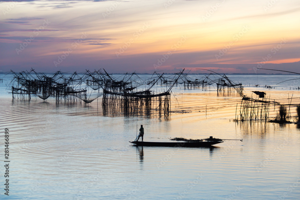 Fototapeta premium Silhouette of square dip nets with sunrise sky background, livelihoods of fishermen at Pakpra, Phatthalung in Thailand