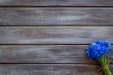 Bouquet of blue cornflowers on wooden background top view mockup