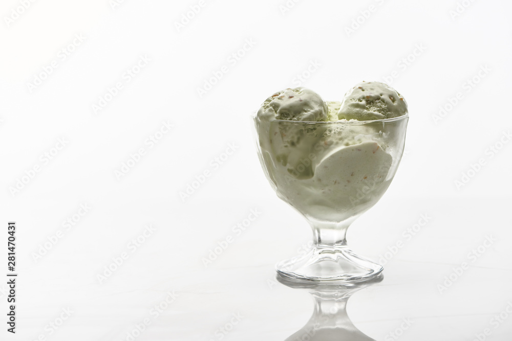 delicious pistachio ice cream in glass bowl isolated on white delicious pistachio ice cream in glass bowl isolated on white