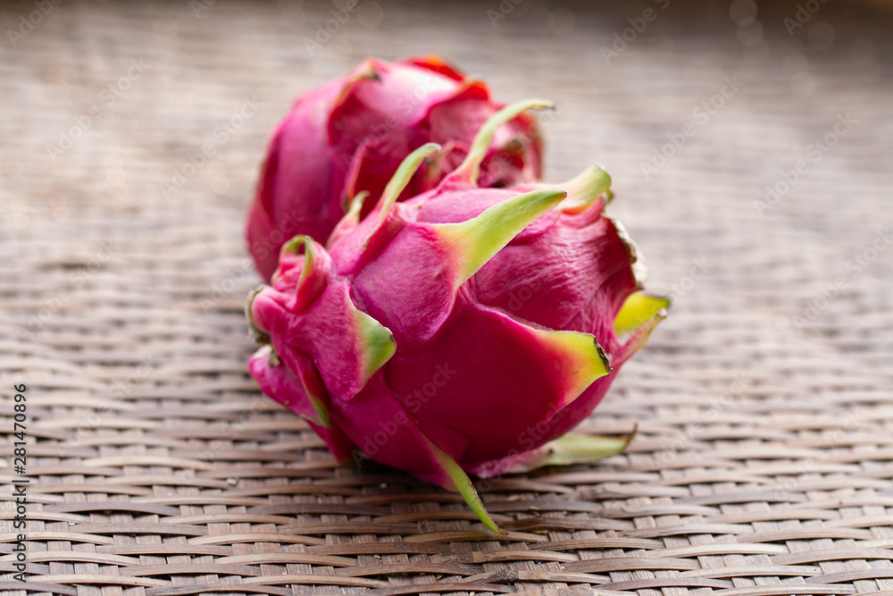 Fresh pitahaya fruit on wooden background or ripe dragon fruit red color with copy-space