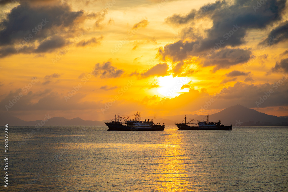Fishing boats on sea in sunset lights in Sanya, Hainan, China Fishing boats on sea in sunset lights in Sanya, Hainan, China