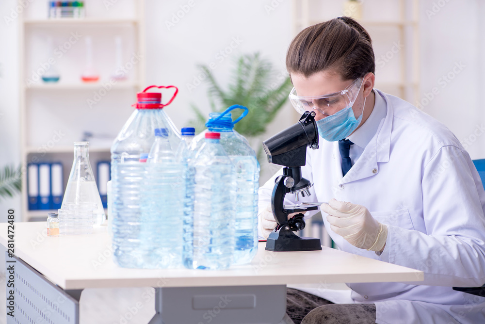 Young male chemist experimenting in lab Young male chemist experimenting in lab