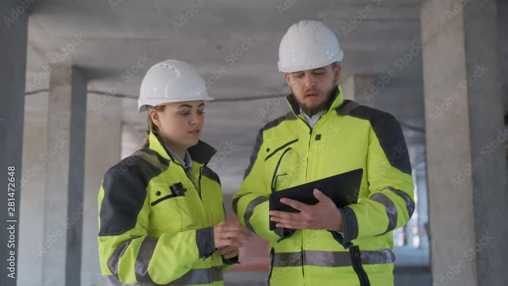 Architect or engineer working, browsing building project indoor of construction site with blueprint plan. businessman worker, man male construction engineers or architects working people. Two Engineer Architect or engineer working, browsing building project indoor of construction site with blueprint plan. businessman worker, man male construction engineers or architects working people. Two Engineer
