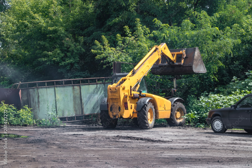 Orange excavator on wheels, earthmoving machinery for construction and earthworks Orange excavator on wheels, earthmoving machinery for construction and earthworks