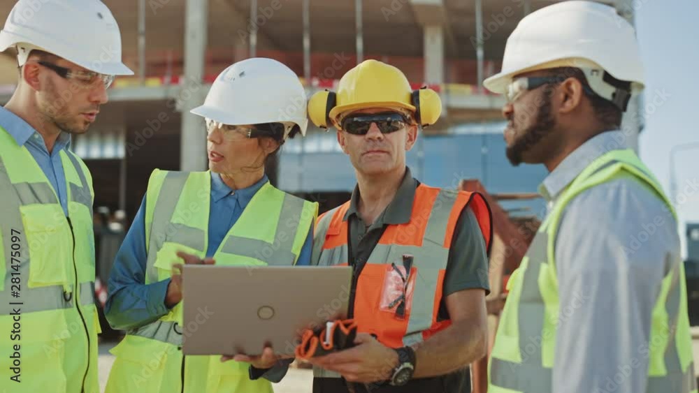 Diverse Team of Specialists Use Laptop Computer on Construction Site. Real Estate Building Project with Machinery: Civil Engineer, Investor, Businesswoman and Builder Discussing Blueprint Plan Diverse Team of Specialists Use Laptop Computer on Construction Site. Real Estate Building Project with Machinery: Civil Engineer, Investor, Businesswoman and Builder Discussing Blueprint Plan