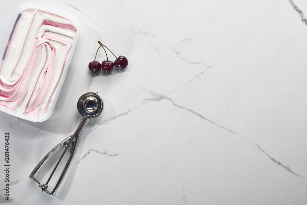 top view of delicious cherries and ice cream on marble grey background with ice cream spoon