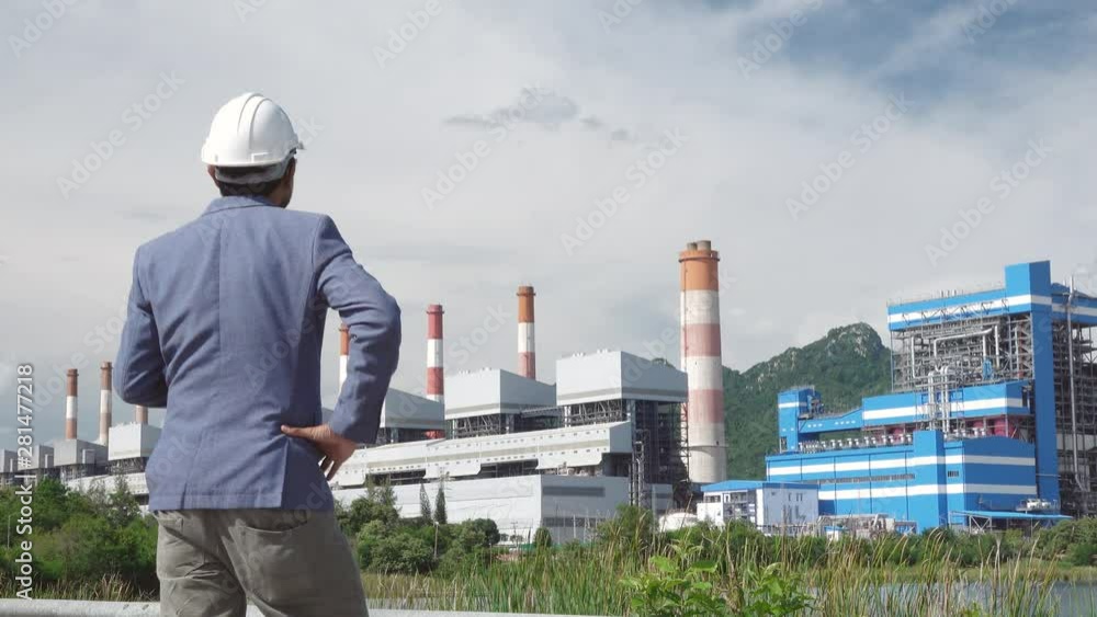 Businessmen at power plant background, safety helmet for safety concept and power plant project site background. Businessmen at power plant background, safety helmet for safety concept and power plant project site background.